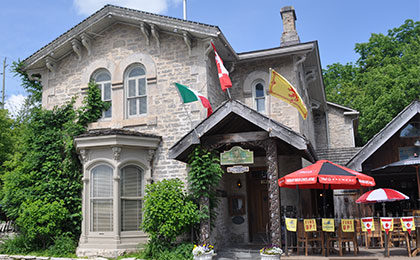 Historic building that features an Inn with two restaurants, each with an outoor patio in downtown Fergus.